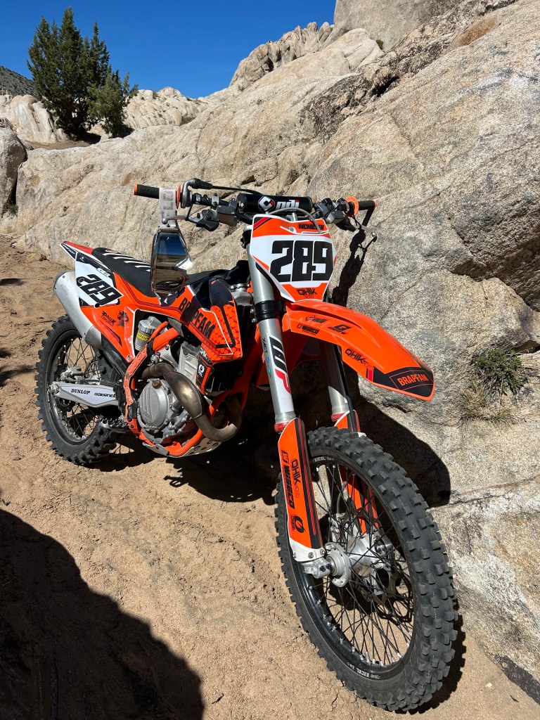 BRAPFAM #289 KTM posed against the rocks